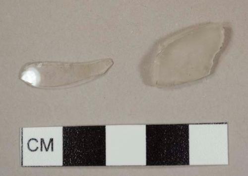 Colorless curved glass fragments, including one possible lamp chimney fragment