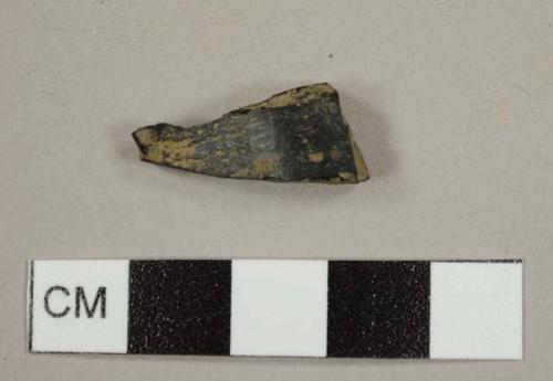 Broken black fragment, most likely plastic