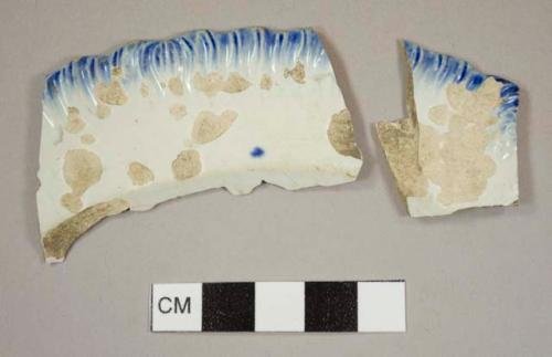 Pearlware plate rim sherds with a blue shell edge, pieces mend together