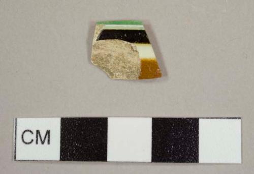 Annular ware sherd with tan, white, brown, and green bands