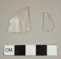 Colorless curved glass fragments, one with molded facets and most likely from a tumbler