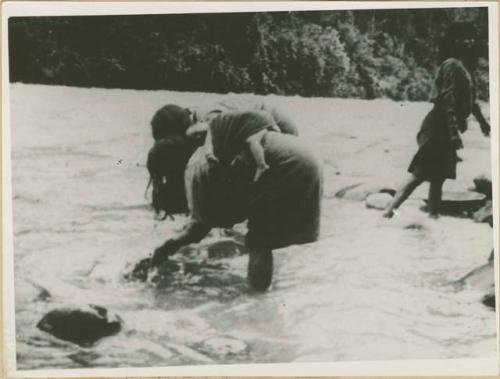 Woman with baby washing gold