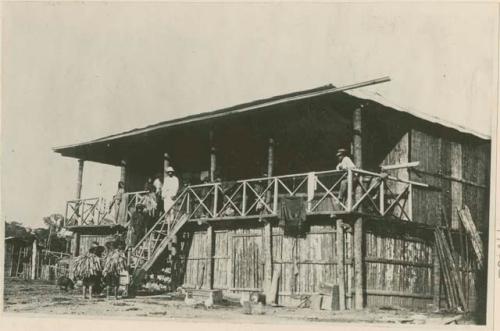 Group of people standing on and near a structure