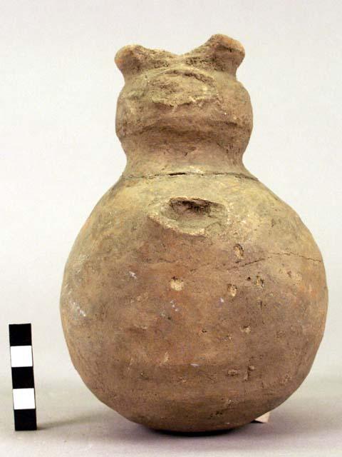 Earthen jug with handles and face broken