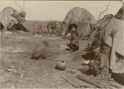 People in front of huts