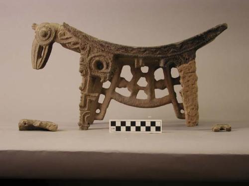 Fragments of stone metate with effigy bird head