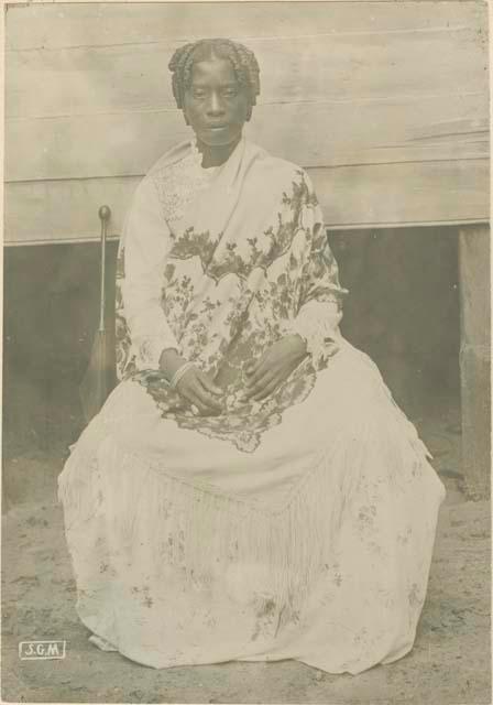 Woman sitting in front of building