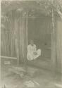 Woman sitting in doorway