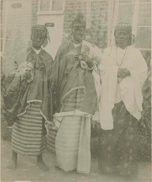 Three women in front of a building