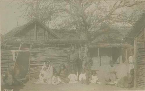 Group sitting in front of structures