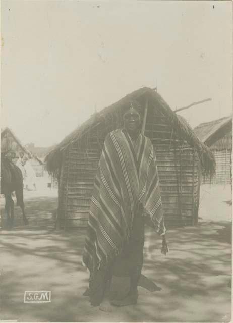 Sakalave woman standing in front of a building