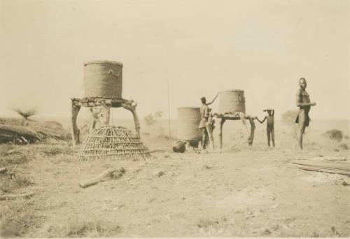 Beginning of a new Madi village - erecting grain bins before houses