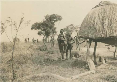 Group standing next to a hut