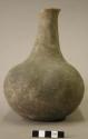 Ceramic complete vessel, long neck, four lobes, groove around shoulder, chipped