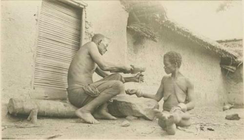 Removing bracelets from arm of woman