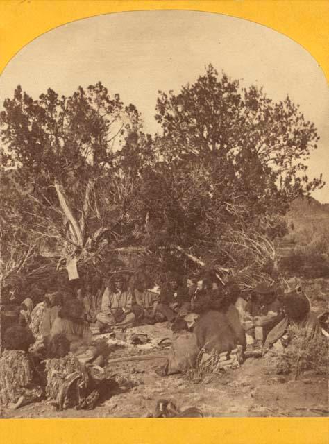 Group of people sitting in circle in camp