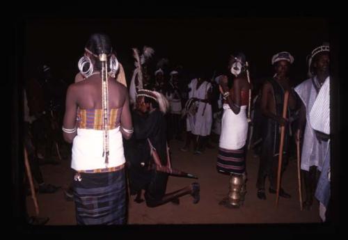 Bororo women in front of line of Gerewol dancers at nighttime - Niger
