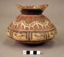 Late Nasca collared jar painted with an abstract serpentine design drawn over a row of female faces