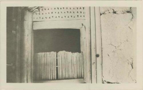 Door of hut made of ends of oil palm fronds