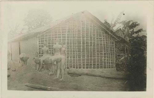 Front side of hut with first coat of mud