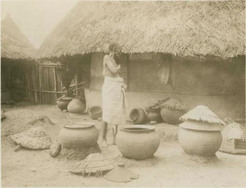 Man standing next to lye pots