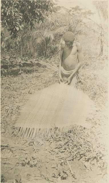 Boy making mat