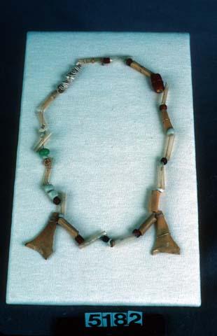 String of beads worn by women--beads of several kinds--several quills, pieces of