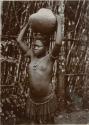 Woman carrying a ceramic vessel on her head