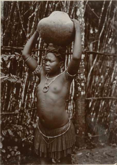 Woman carrying a ceramic vessel on her head