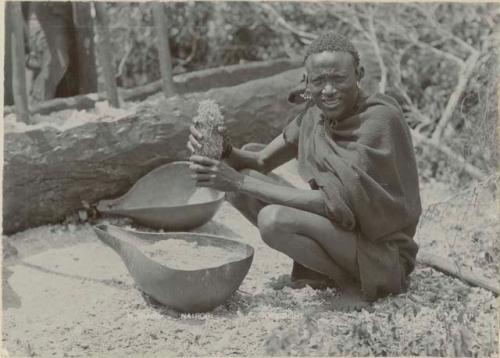 Man extracting sugarcane juice for beer-making