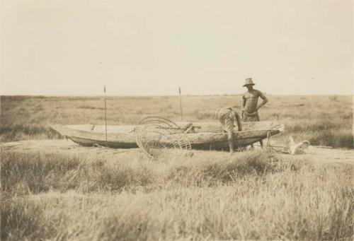 Canoe made of slabs of bark roughly sewed together