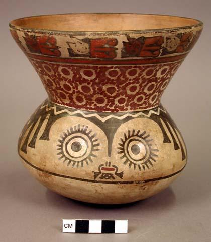 Ceramic jar, human head body, flaring headdress rim, recessed eyes, polychrome