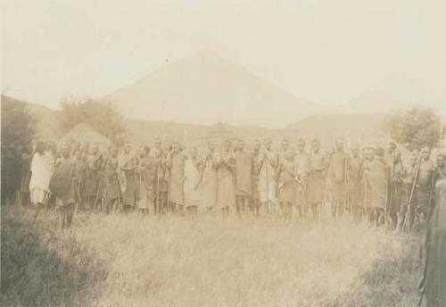 Group standing, with mountain in background