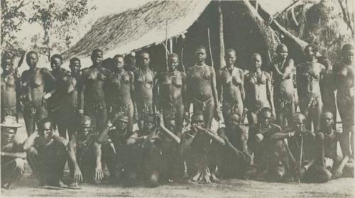 Group standing in front of a hut