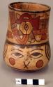 Ceramic cup,polychrome, human face w/ molded nose, eyes looking up, zoomorphic