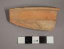 Ceramic rolled rim sherd, with painted band along edge