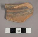 Ceramic rim sherd with painted banded design on exterior