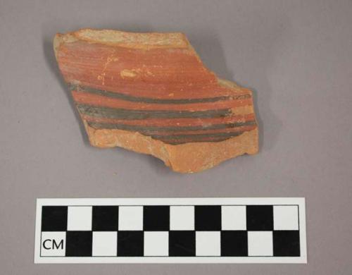 Ceramic body sherd, curved with painted banded design on exterior