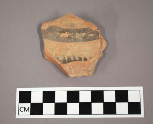 Ceramic body sherd, curved with painted geometric design on exterior