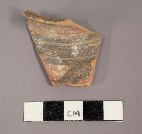 Ceramic rim sherd, curved with painted geometric design on exterior