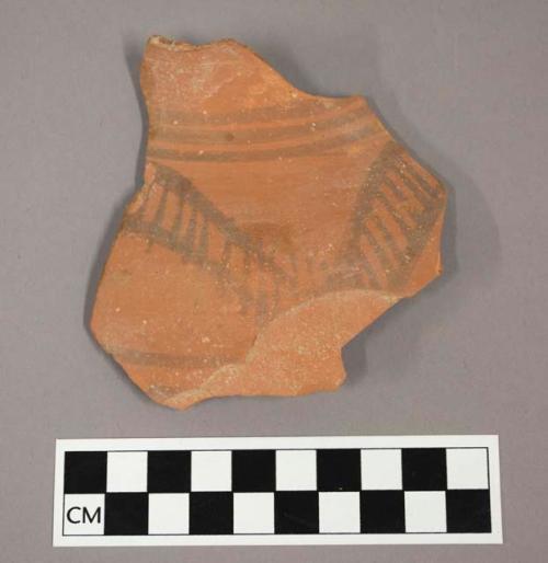 Ceramic body sherd, curved with painted geometric design on exterior