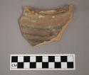 Ceramic rim sherd, curved with painted banded design on exterior