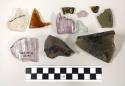 Glass fragments, including 2 from wooden moulds. colors: dark green, purple, cl