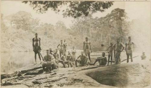 George Schwab and group sitting on rock next to the river