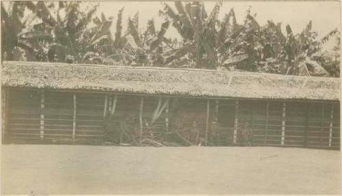 Group sitting in front of a hut