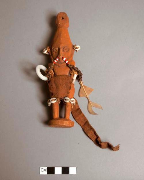 Small carved wooden male figure - decorated with beads and shell