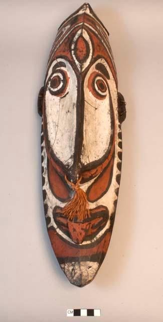 Carved wooden head - painted red, white and black