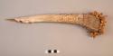 Bone dagger engraved with designs and fiber embedded with seeds as +