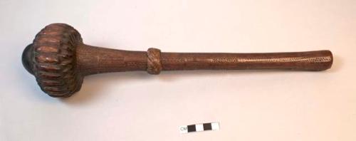 Carved club of dark wood with bulbous carved head