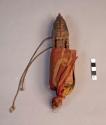Wooden house idol, carved human head, body wrapped in red cloth